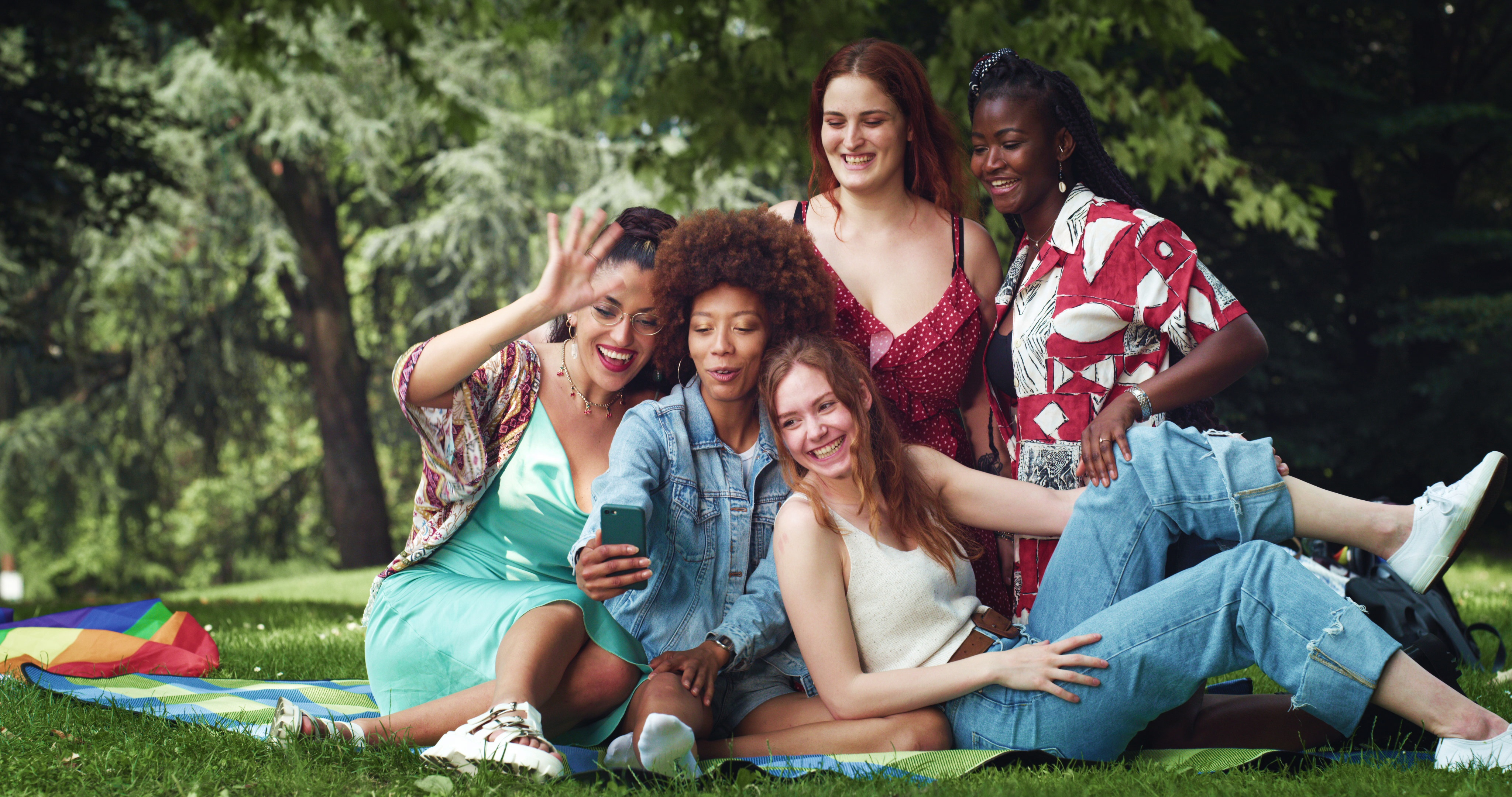 Women smiling around phone