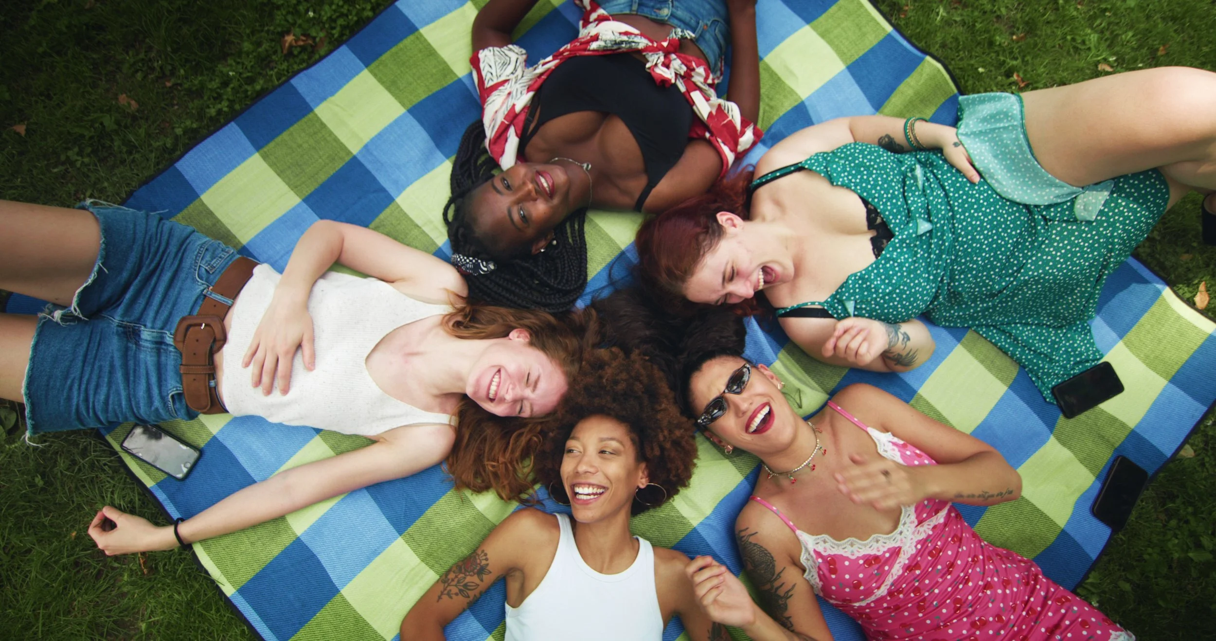 Women lying on blanket laughing
